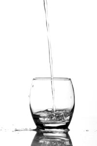 Water being poured into a drinking glass